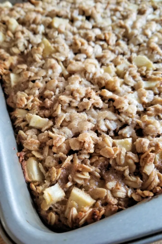 a closeup of apple maple baked oatmeal in a pan
