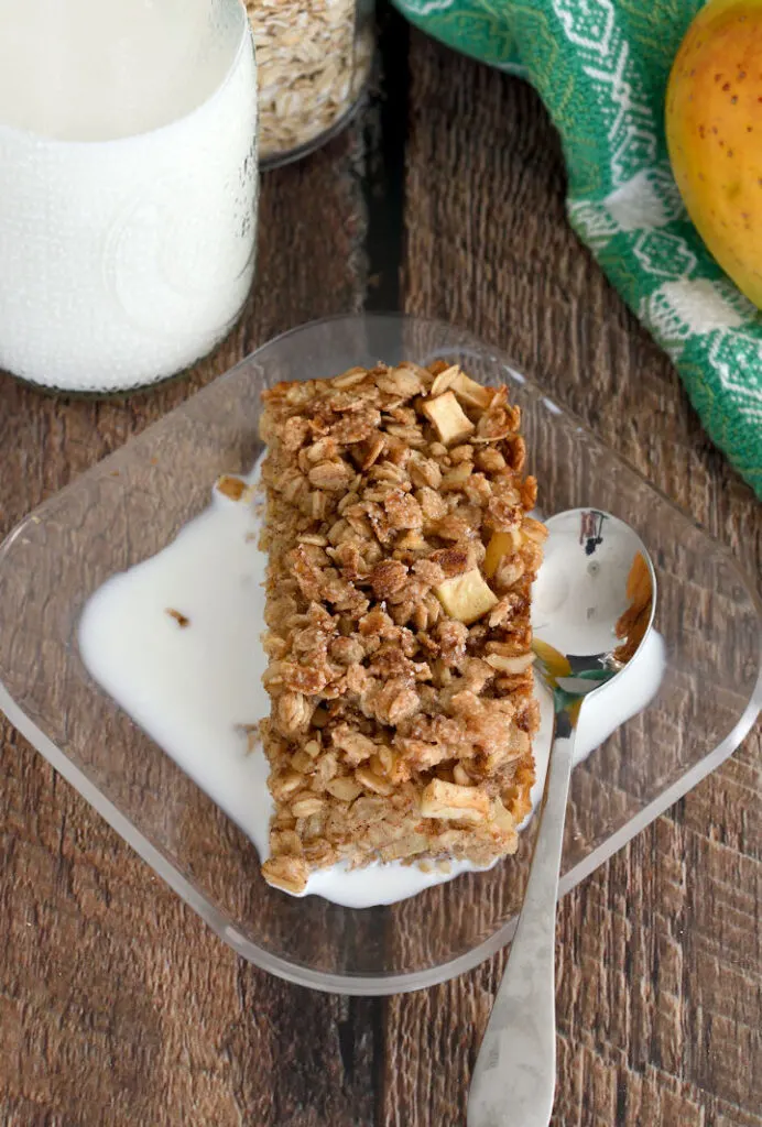 a serving of apple maple baked oatmeal on a plate with milk.
