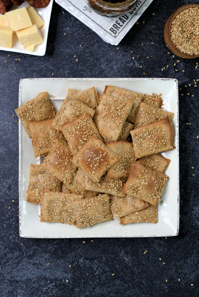 a plate of sourdough crackers with sesame seeds