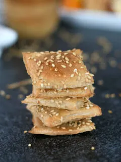 a stack of sourdough crackers with sesame seeds