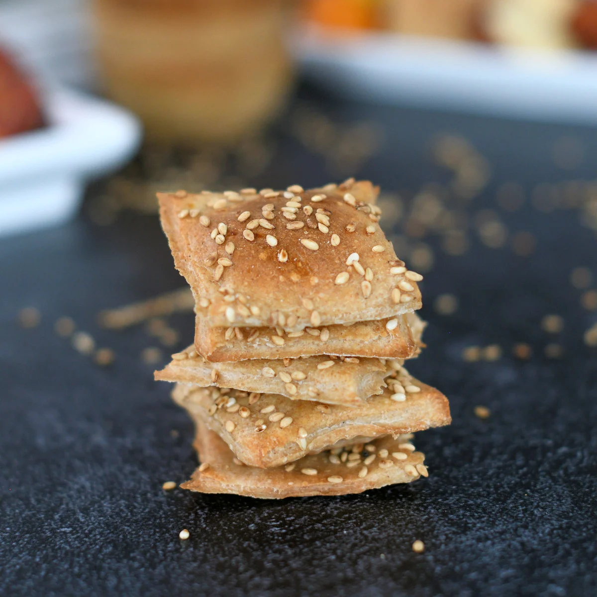 a stack of sourdough crackers with sesame seeds