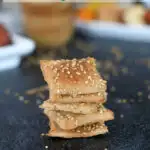 a pinterest image for sourdough whole wheat crackers with text overlay