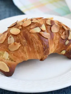 an almond croissant on a plate