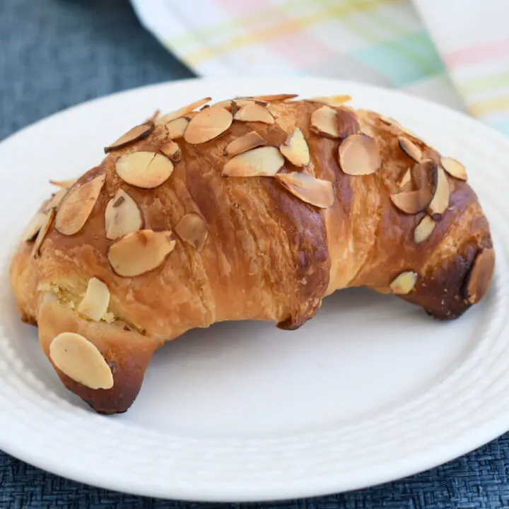 an almond croissant on a plate