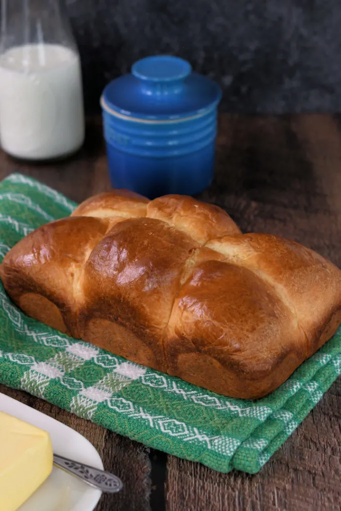 a loaf of sourdough brioche on a green towel