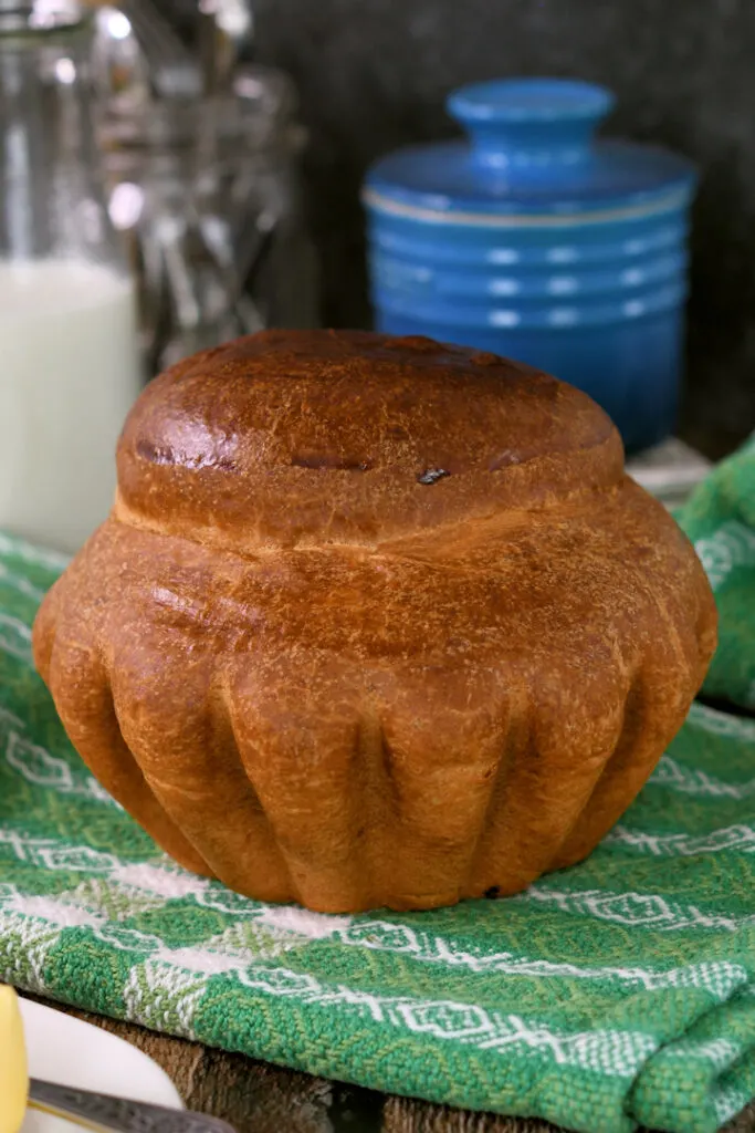 a tete loaf of sourdough brioche on a green towel