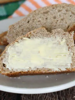 a slice of irish brown bread with butter on a plate