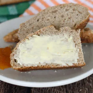 a slice of irish brown bread with butter on a plate