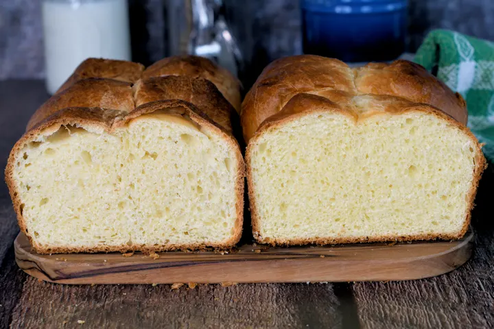 a loaf of sourdough brioche next to a loaf of classic brioche. Showing the difference in texture.