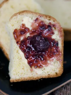 a slice of sourdough brioche topped with butter and jam