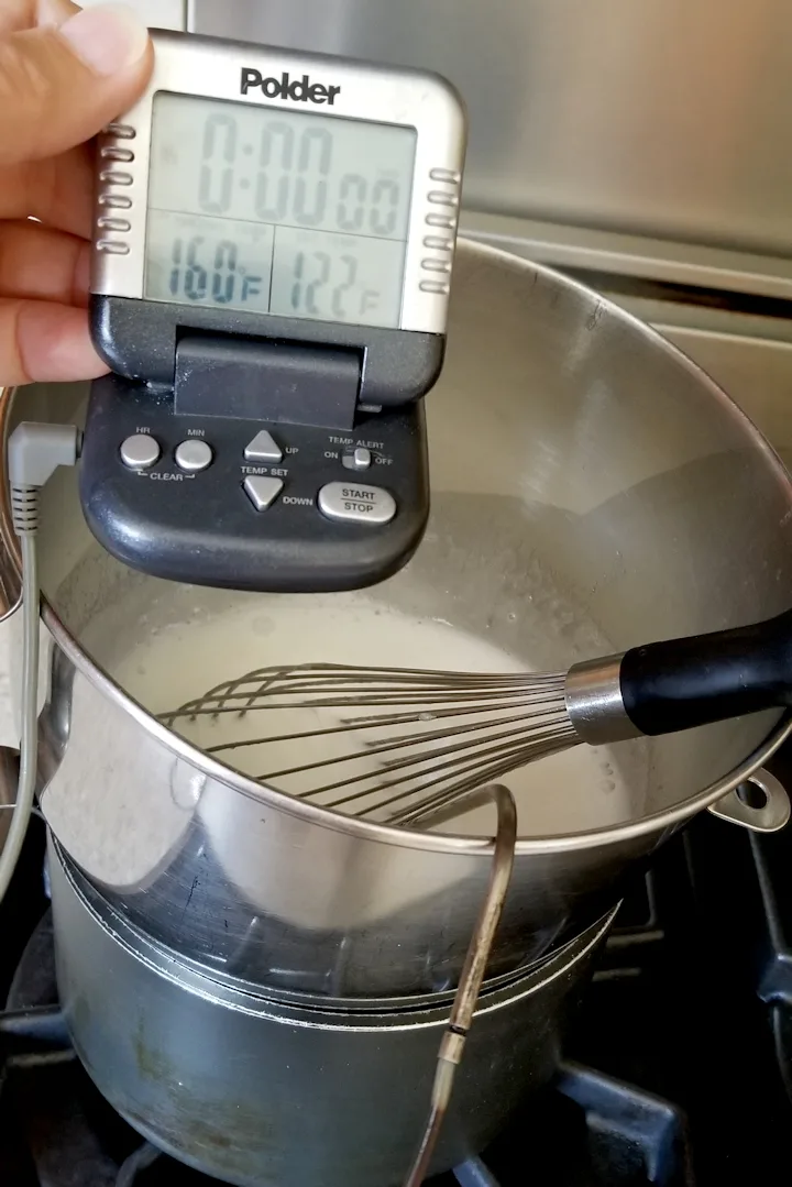 showing how to cook 7 minute frosting over simmering water