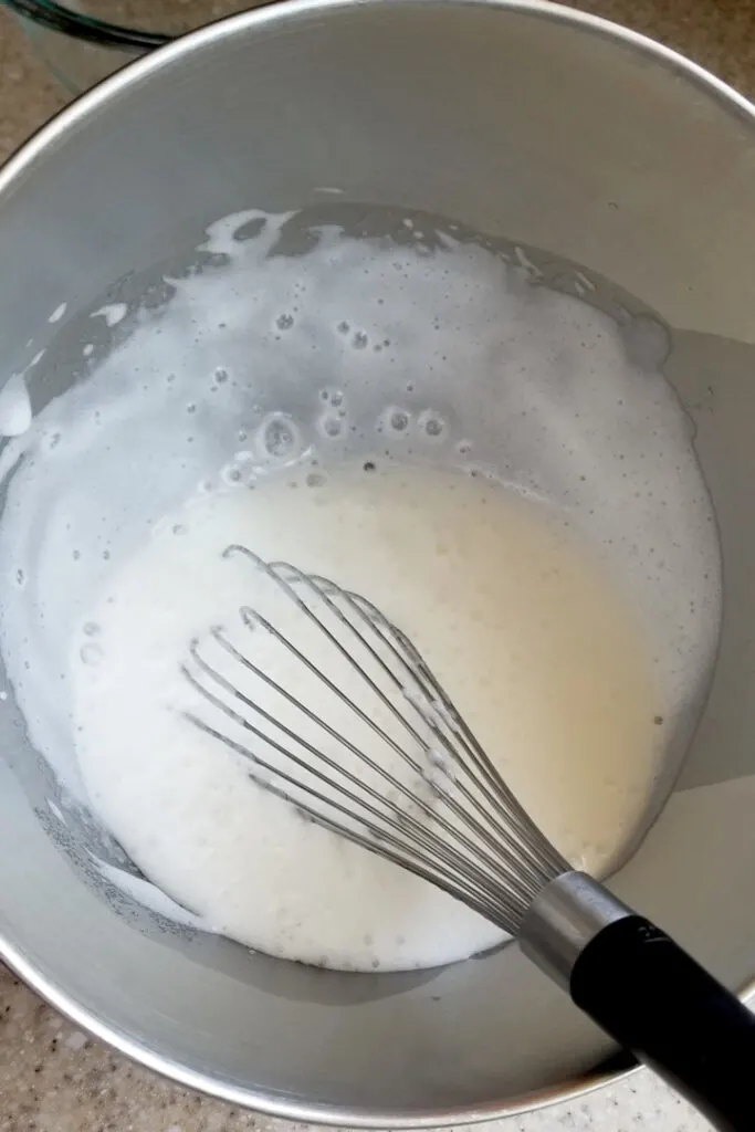 showing how egg whites look after whisking over boiling water