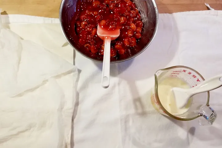 phyllo dough, cherry filing and melted butter on a clean kitchen towel