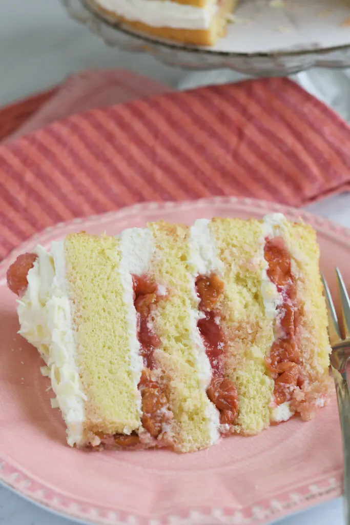 a slice of white forest cake on a pink plate