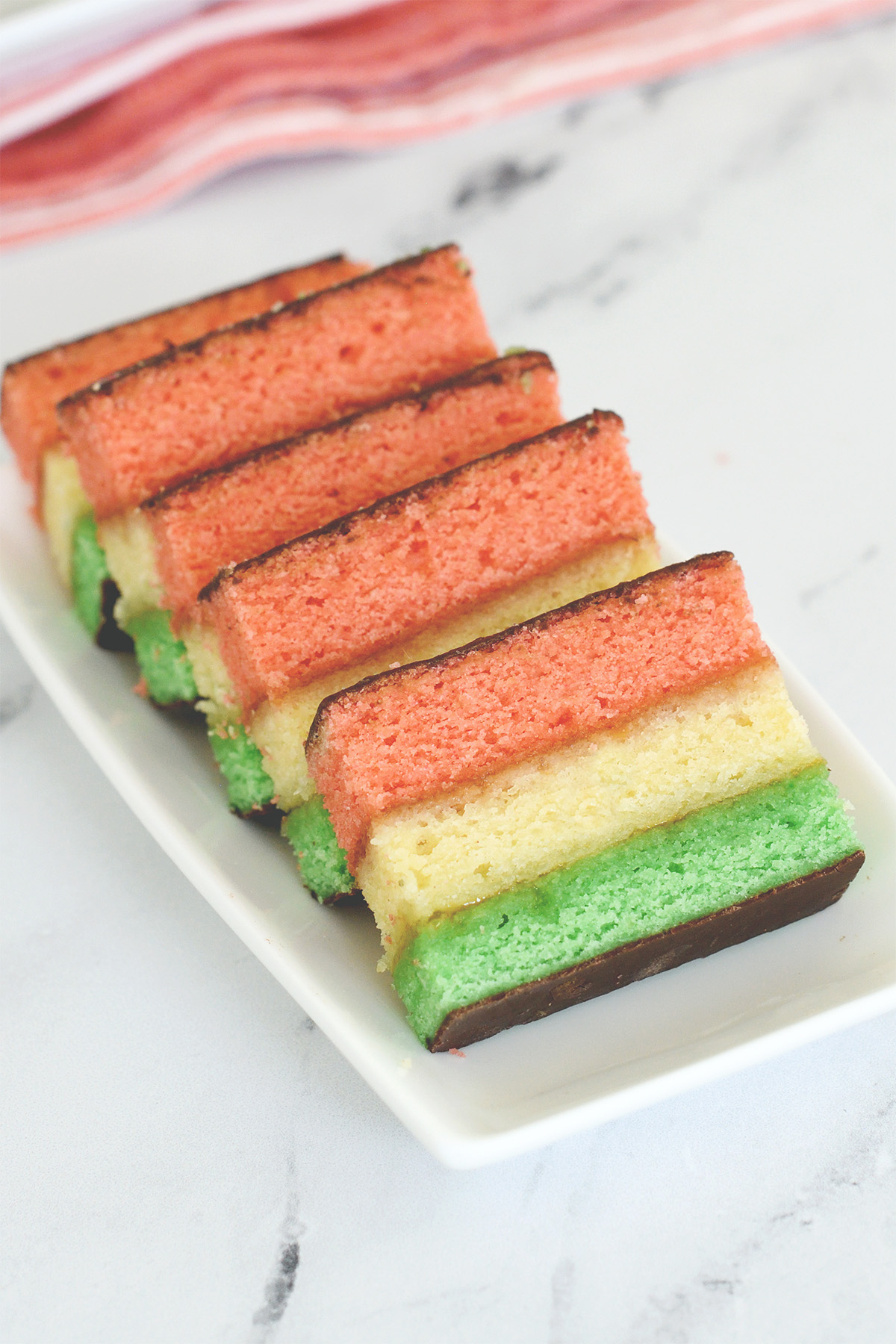 rainbow cookies on a white plate.