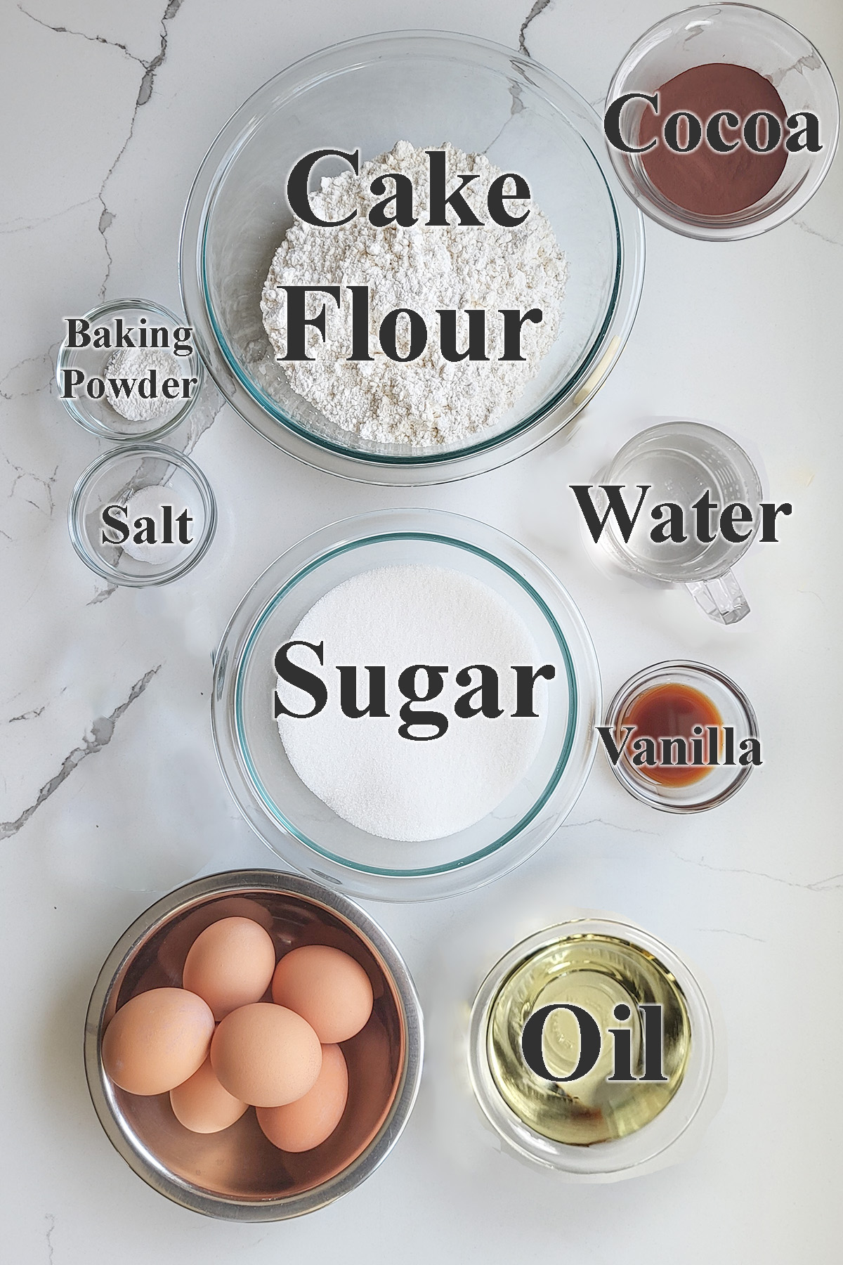 ingredients for chocolate chiffon cake in glass bowls.