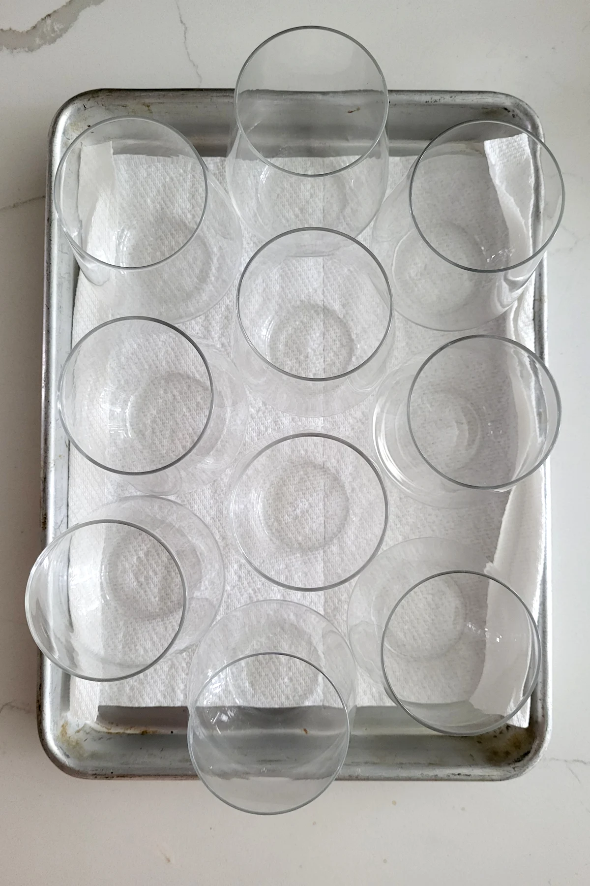 a tray lined with paper towels and empty wine glasses.
