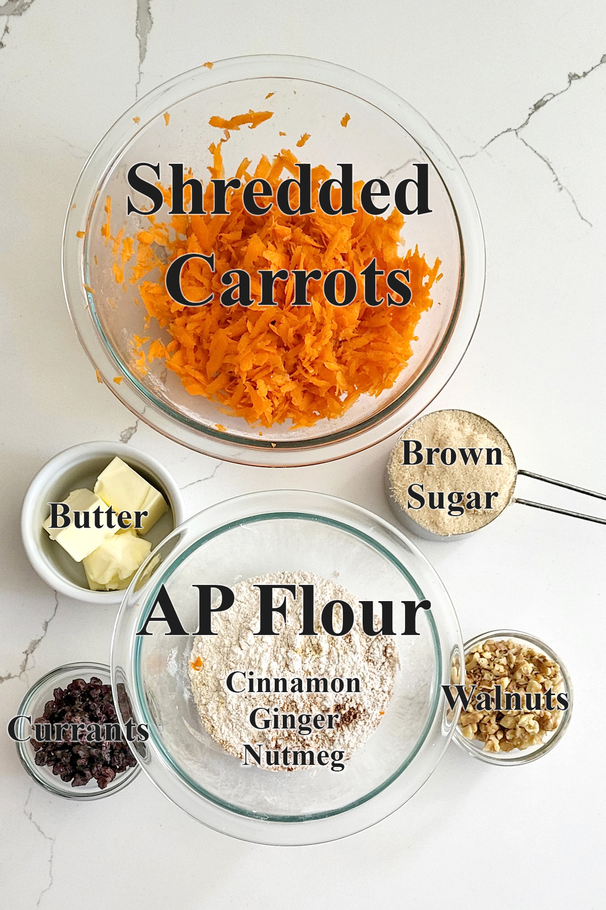 ingredients for carrot cake ice cream dough in glass bowls on a white surface.
