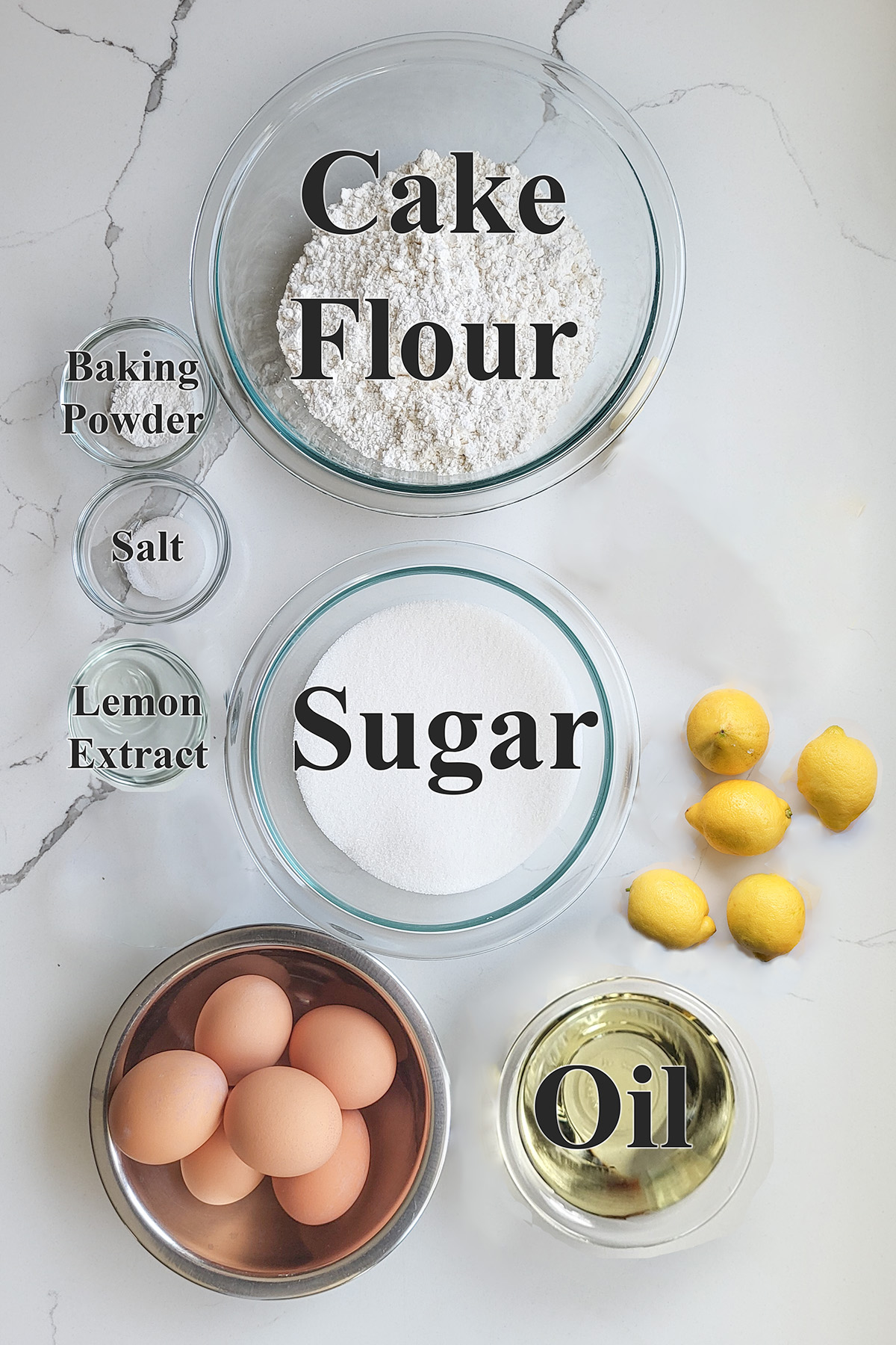 ingredients for lemon chiffon cake in glass bowls.
