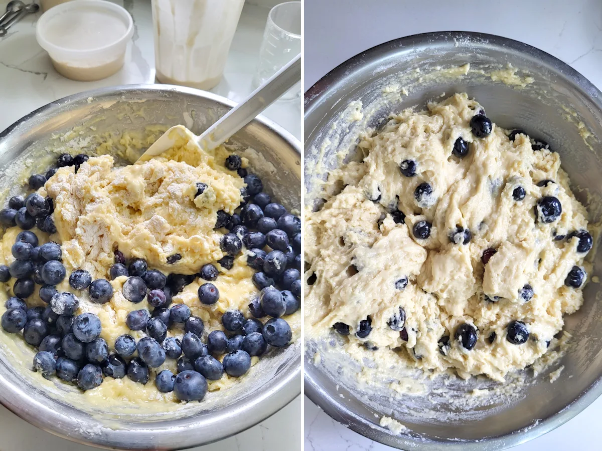 a bowl of muffin dough with blueberries being folded in.