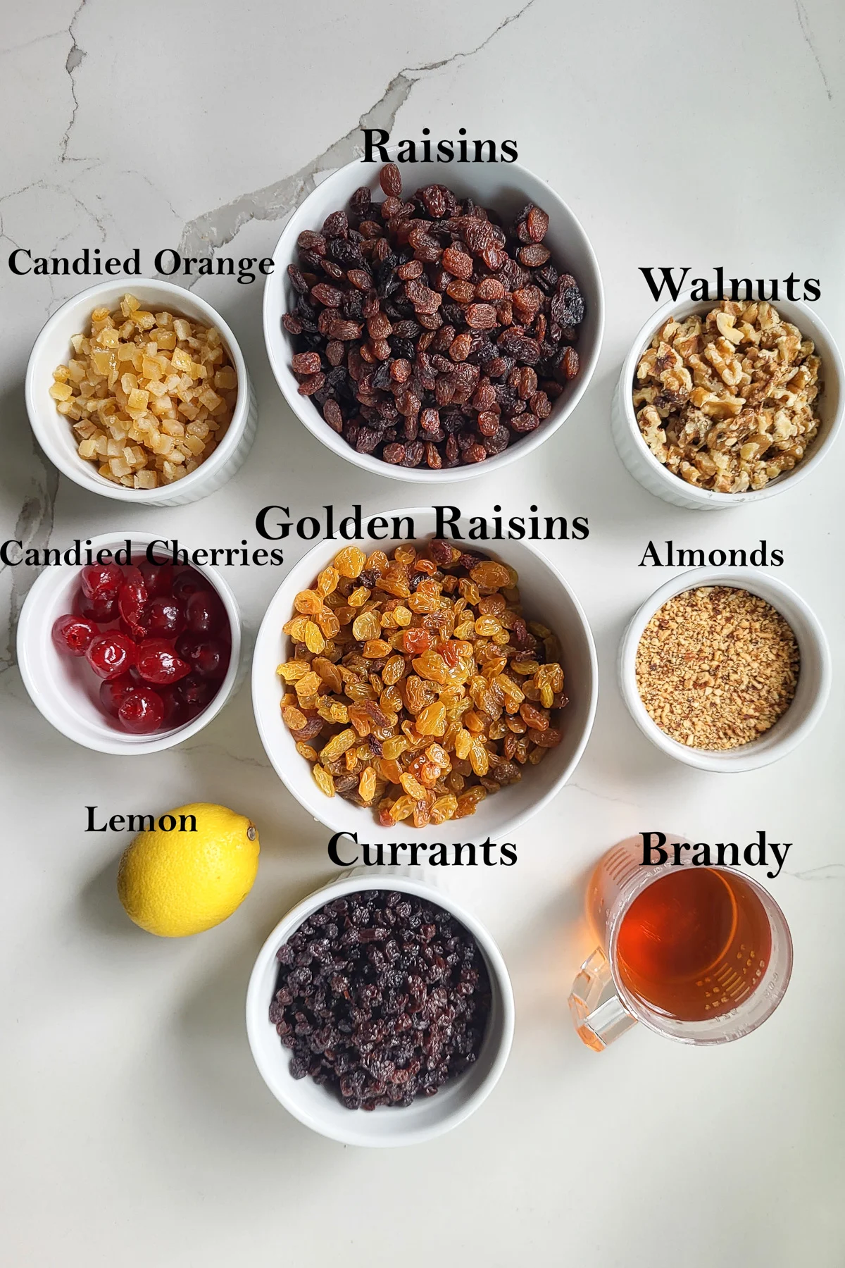 all the fruits and nuts for making fruitcake measured into bowls