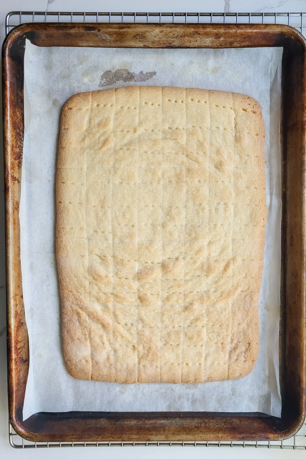 a rectangle of baked shortbread on a tray