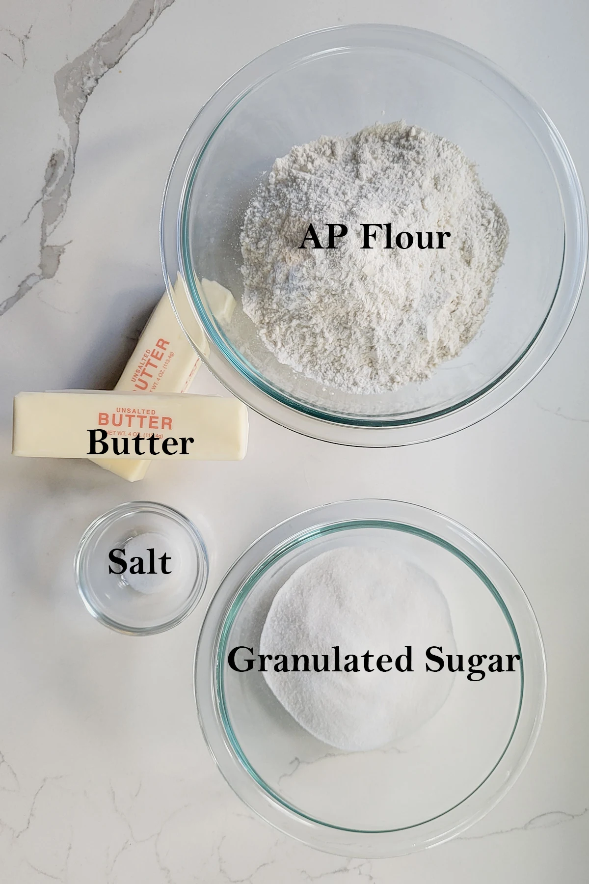 the ingredients for making shortbread dough in bowls