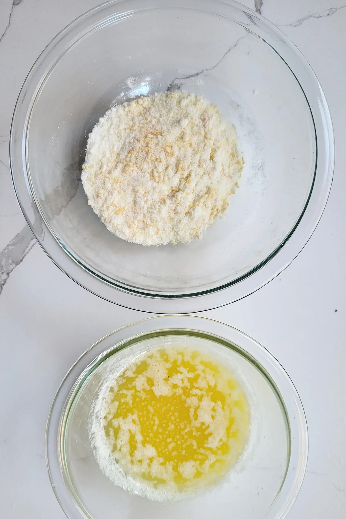 a bowl of orange sugar and a bowl of melted butter.