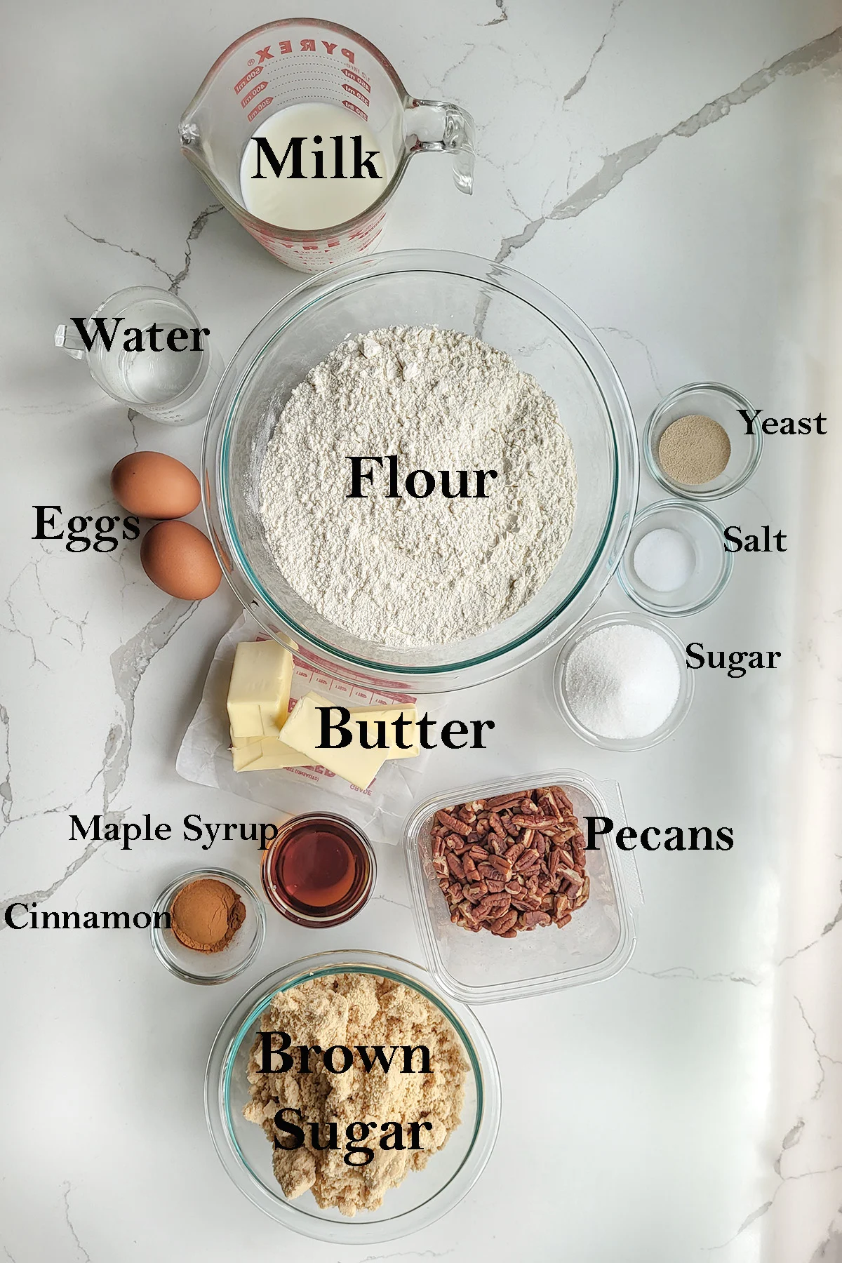 ingredients for making sticky buns arranged in bowls.