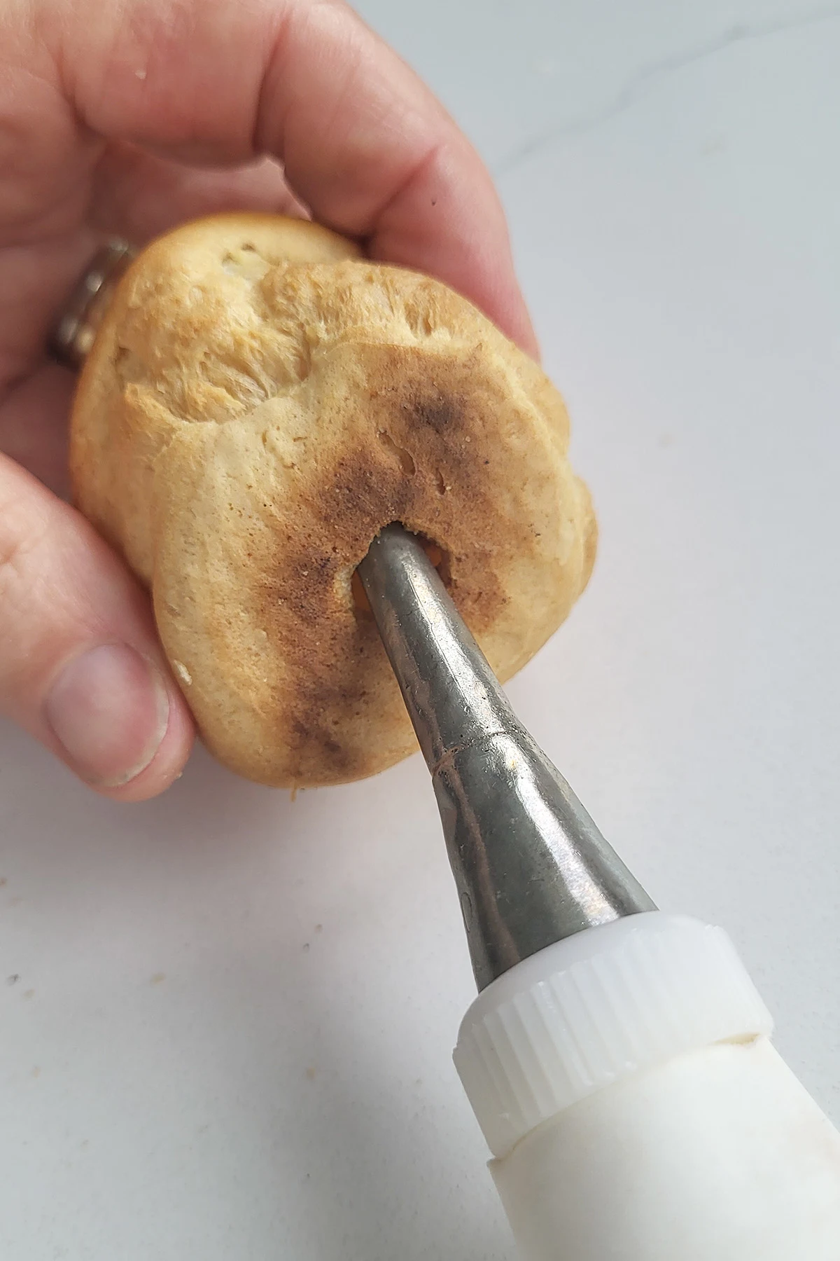a pastry piping tip in a cream puff