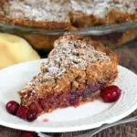 A slice of cranberry pie on a white plate.