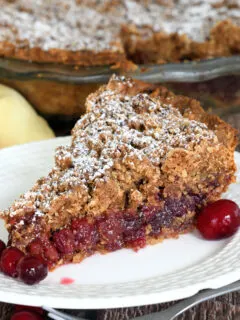 A slice of cranberry pie on a white plate.
