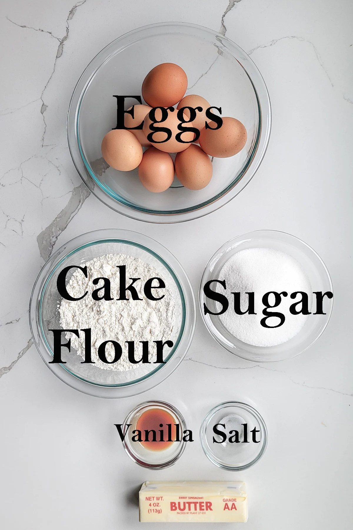 ingredients for genoise sponge cake in bowls with text overlay.