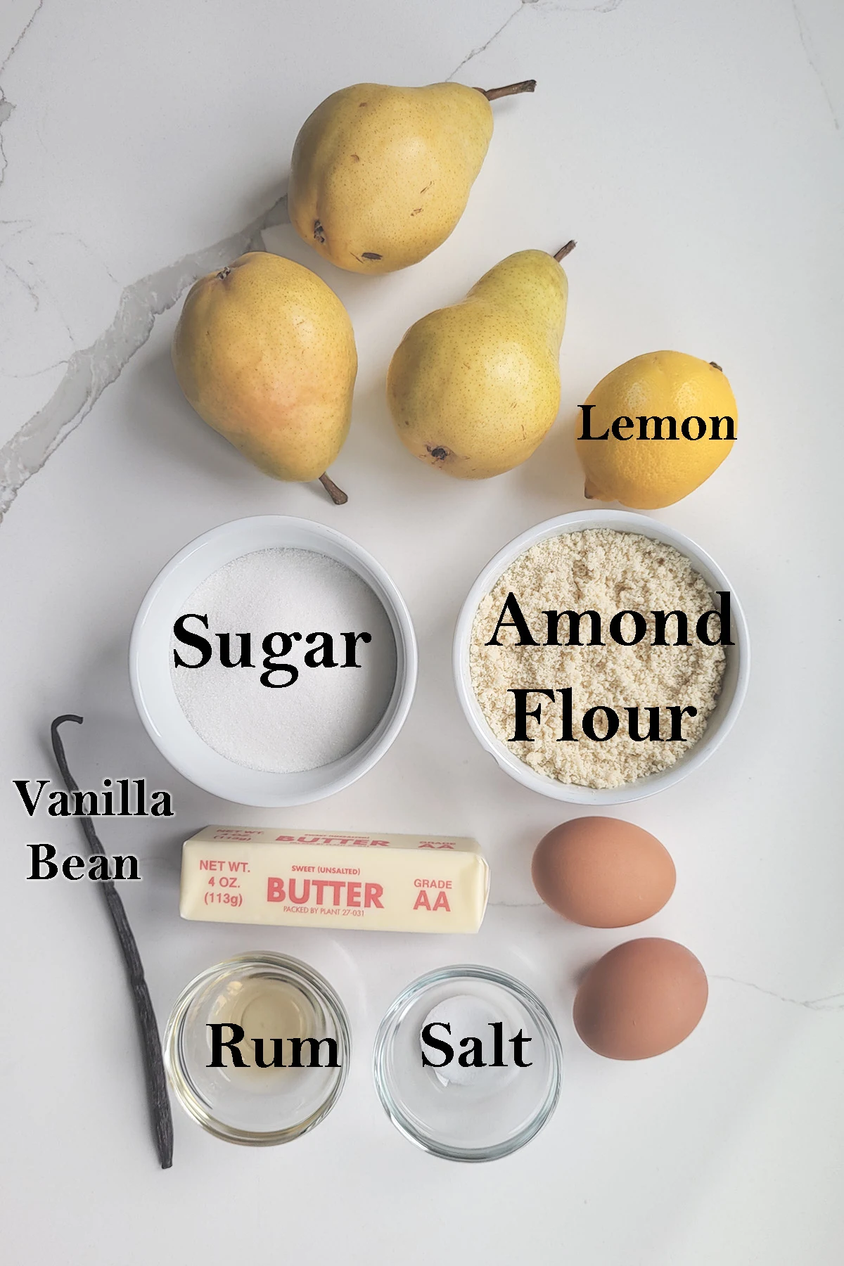 Ingredients for making pear frangipane tart with text overlay.
