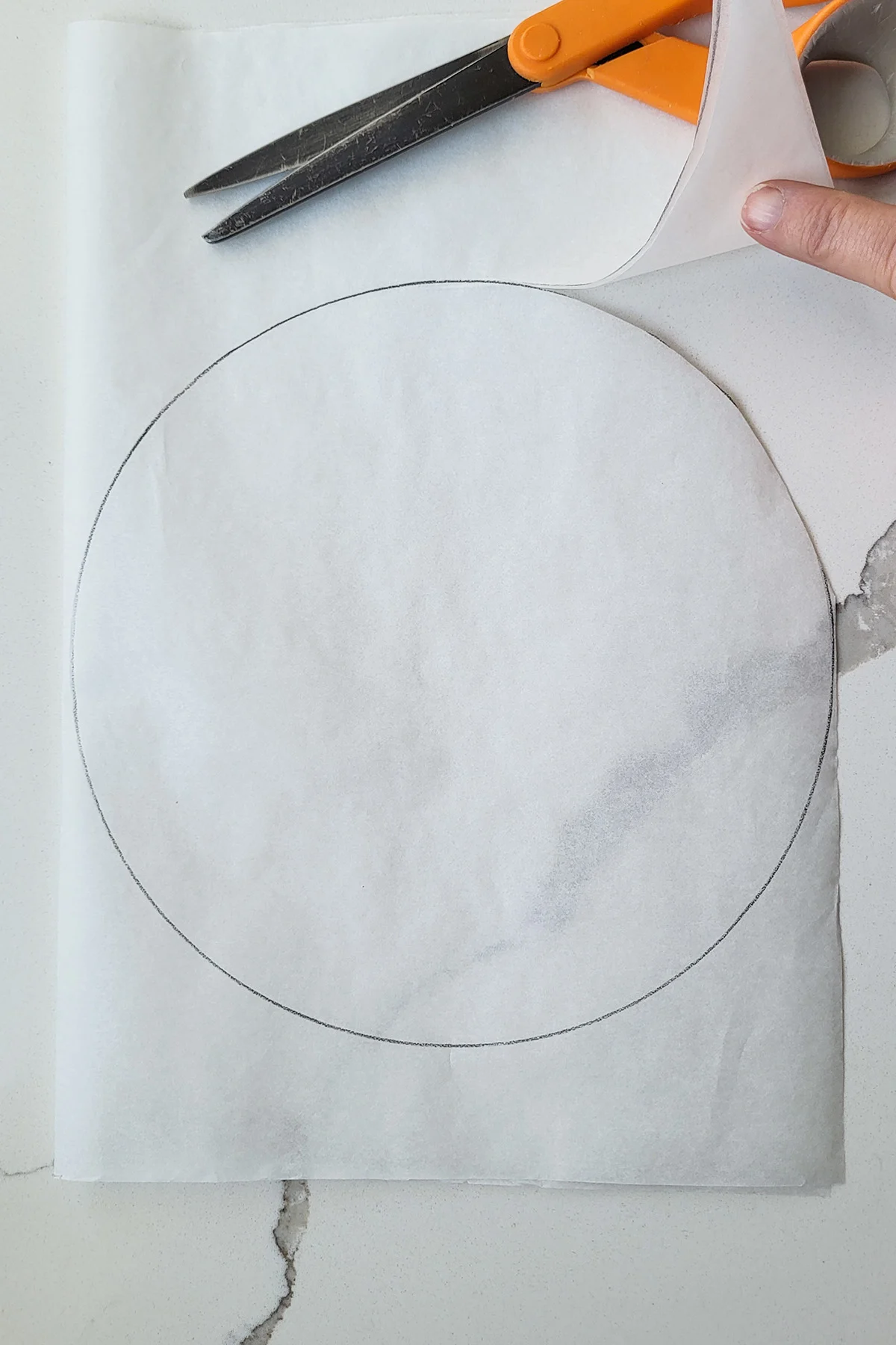 A sheet of parchment paper with a circle cut out.