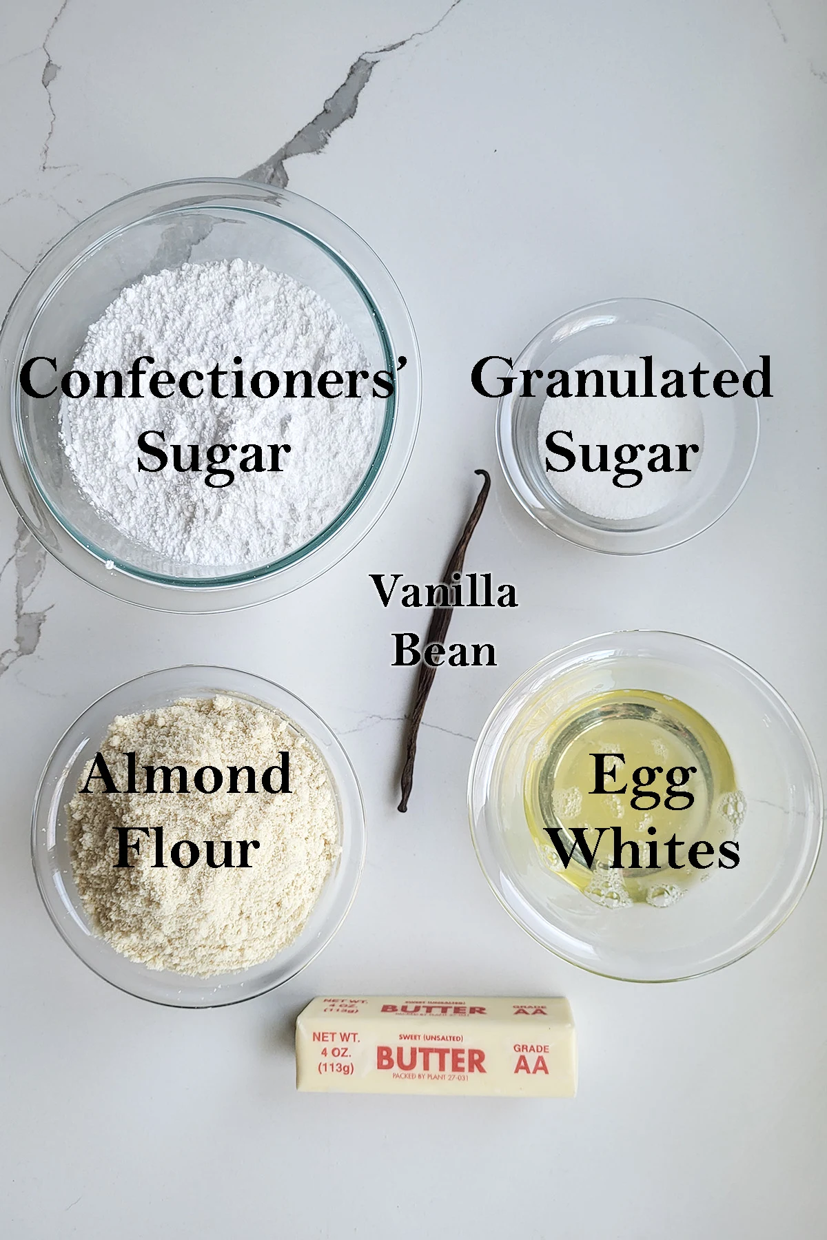 ingredients for vanilla macarons in bowls.