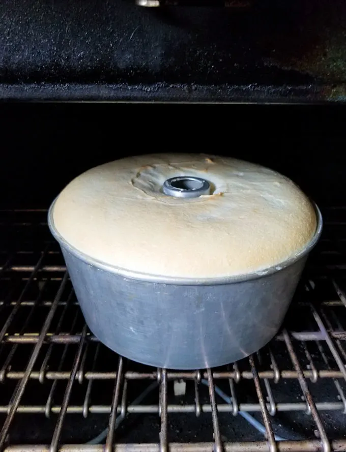 an angel food cake baking in an oven.