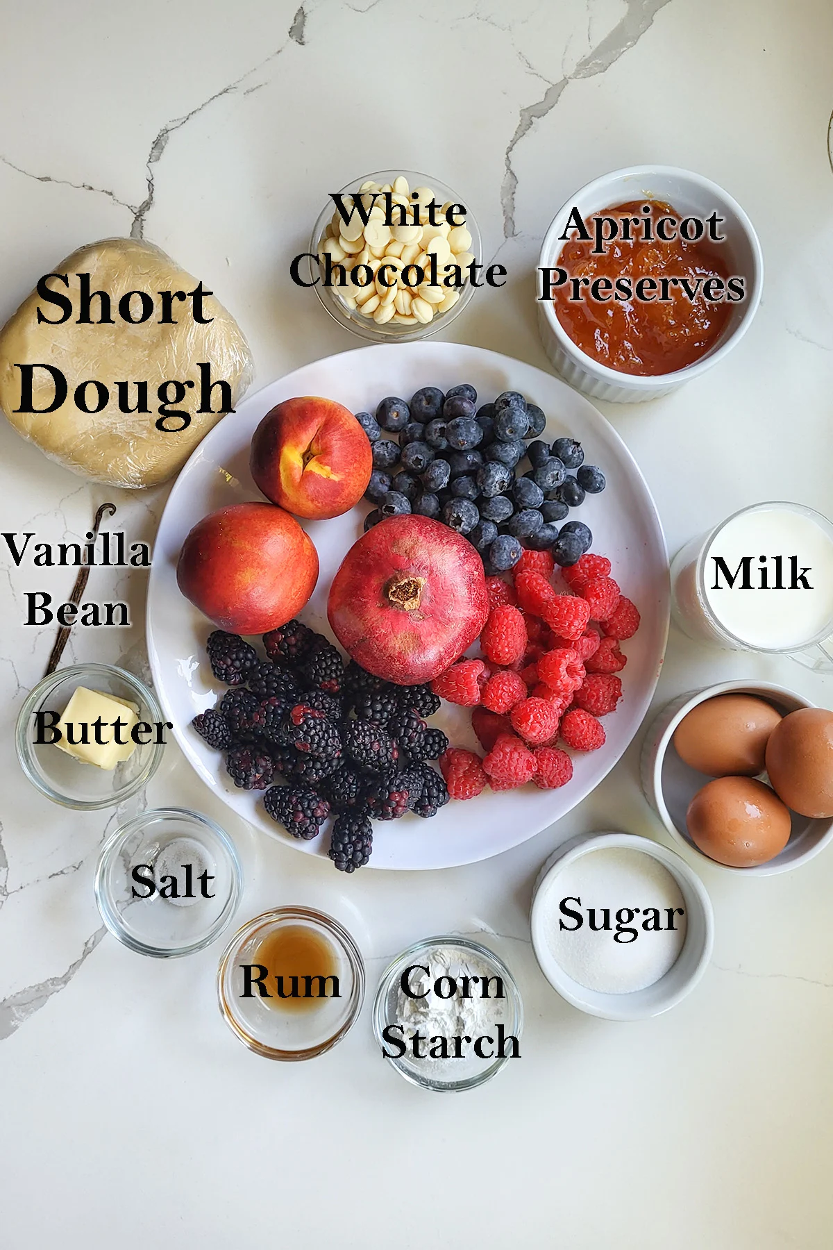 ingredients for fruit tart with custard in bowls.