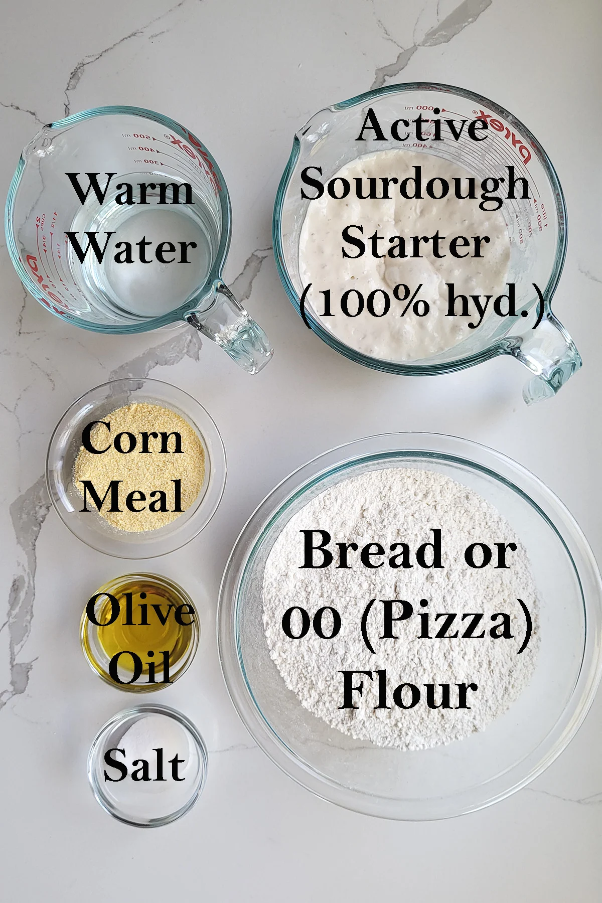 ingredients for sourdough pizza crust in bowls on a white surface.