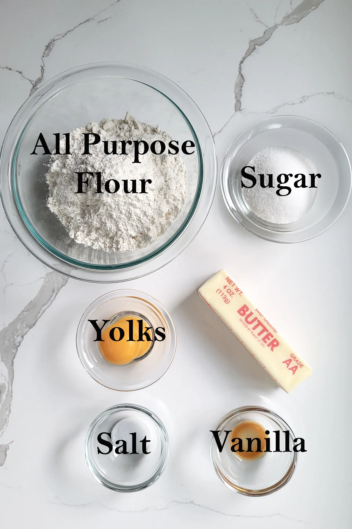 ingredients for sweet tart dough in bowls on a white surface.