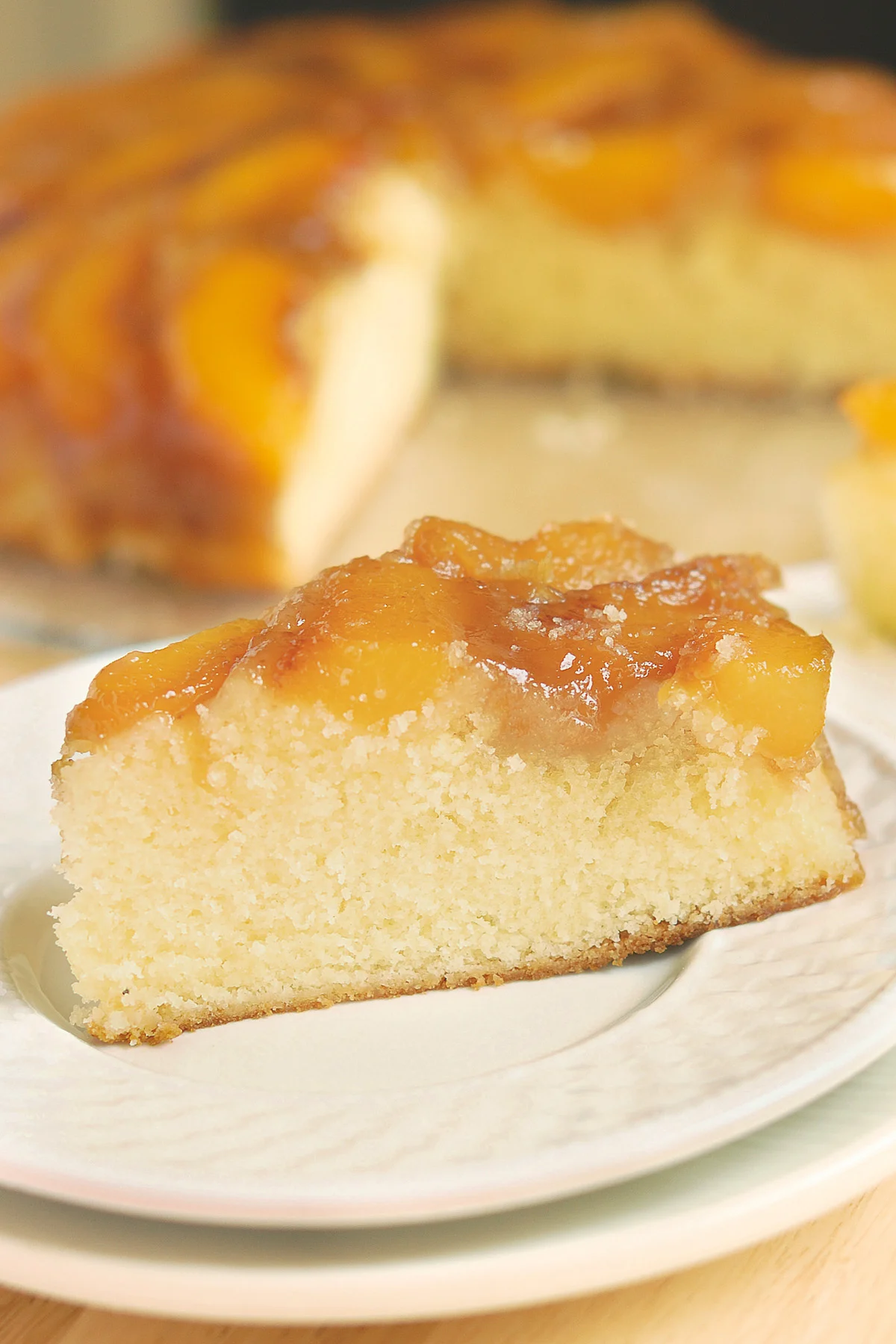 beauty shot of peach upside down cake slice.