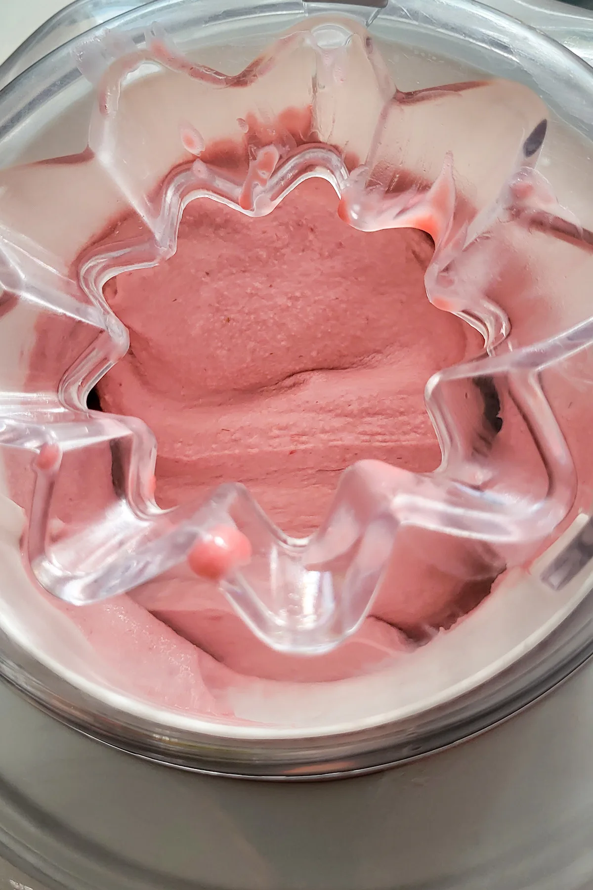 A ice cream machine filled with raspberry ice cream.