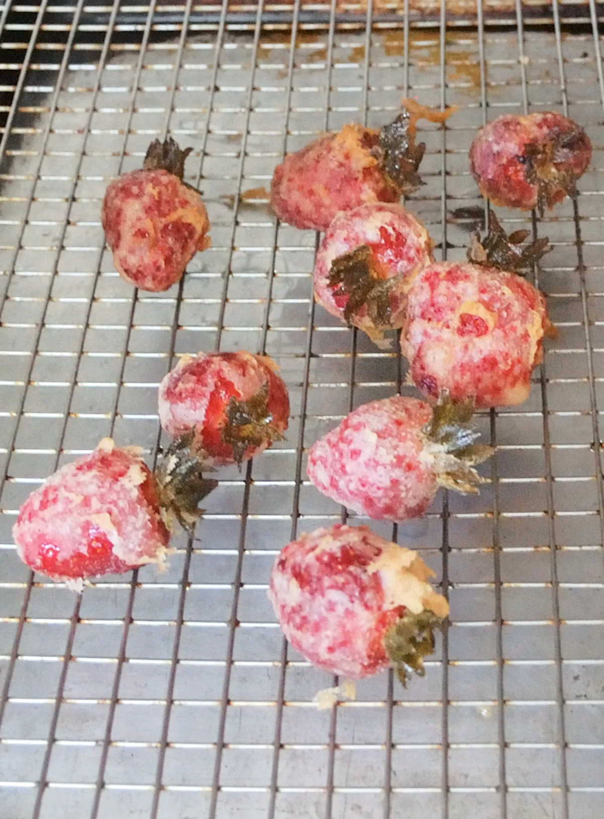 fried strawberries on a cooling rack.