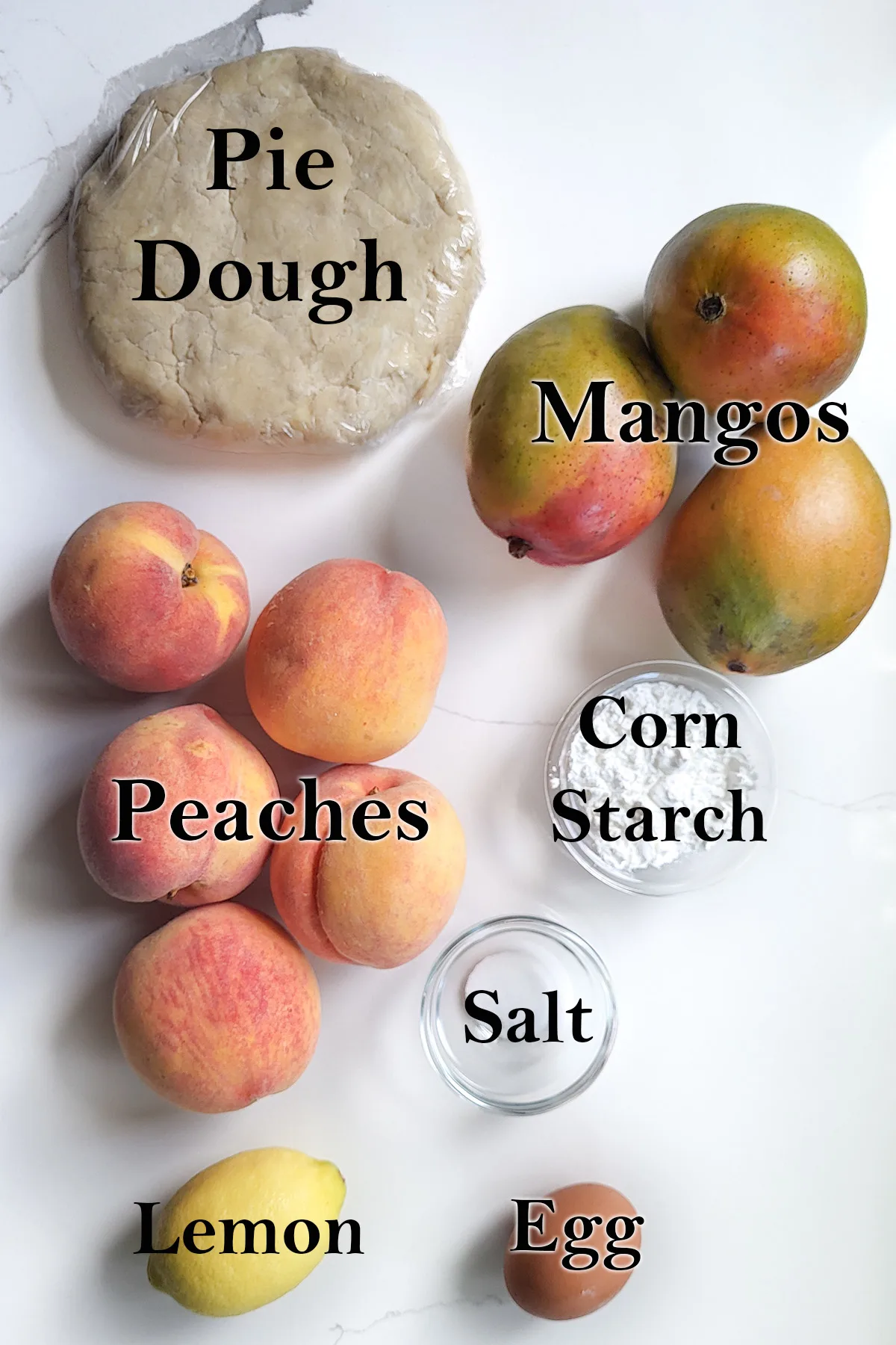 ingredients for peach mango pie on a white background with text overlay.