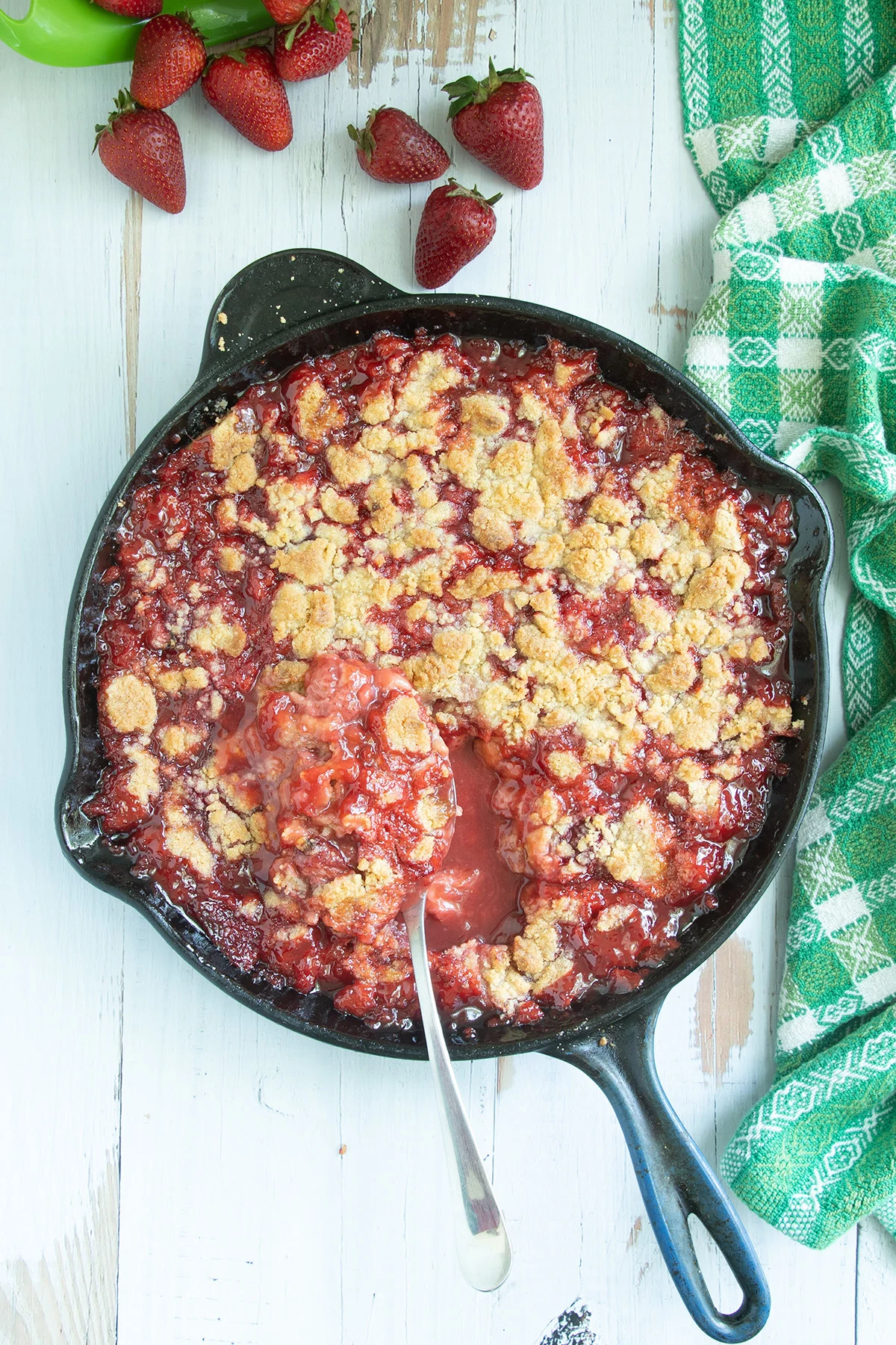 Strawberry crumble in a cast iron skillet.