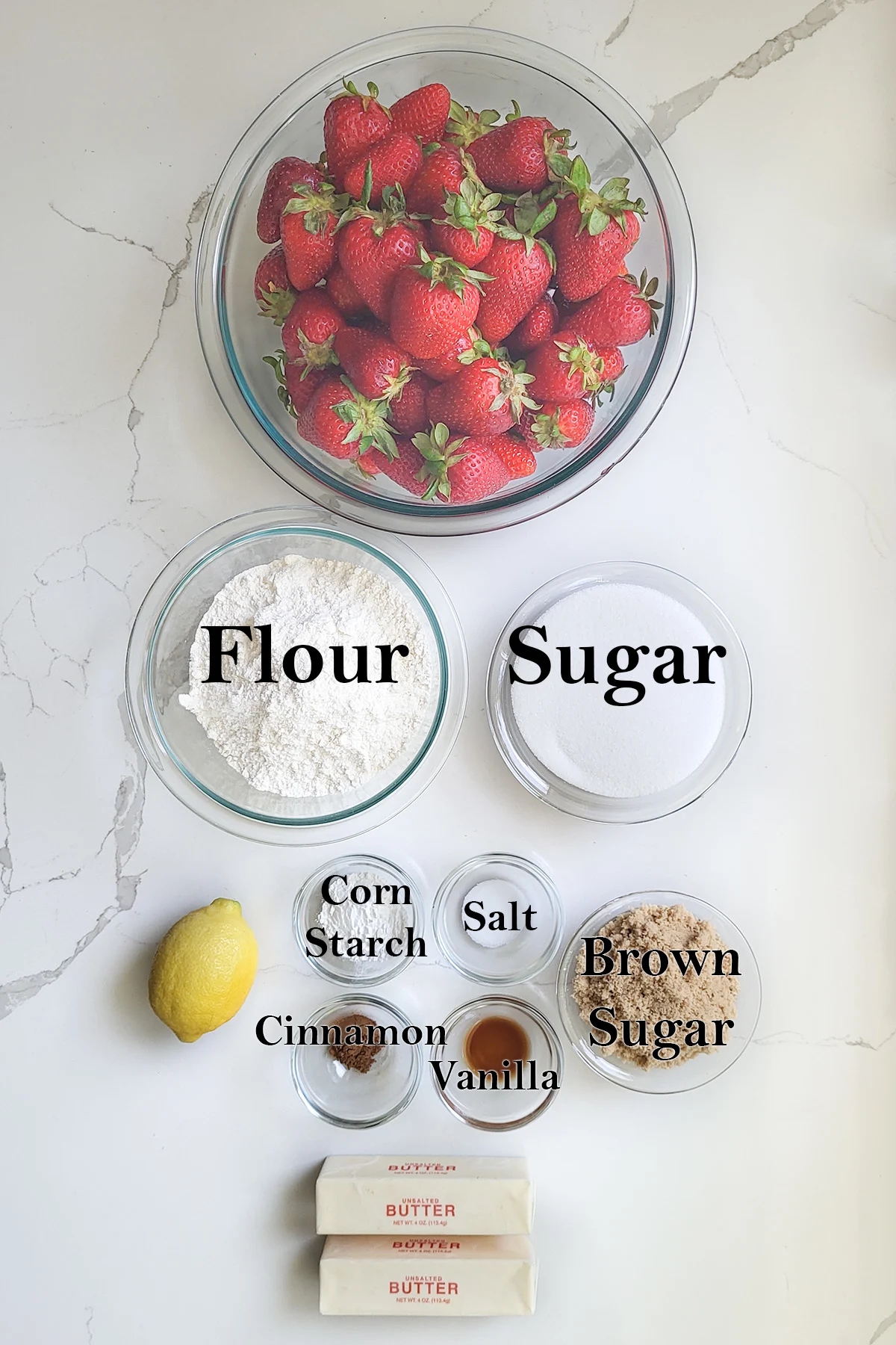 Ingredients for strawberry crisp in bowls.