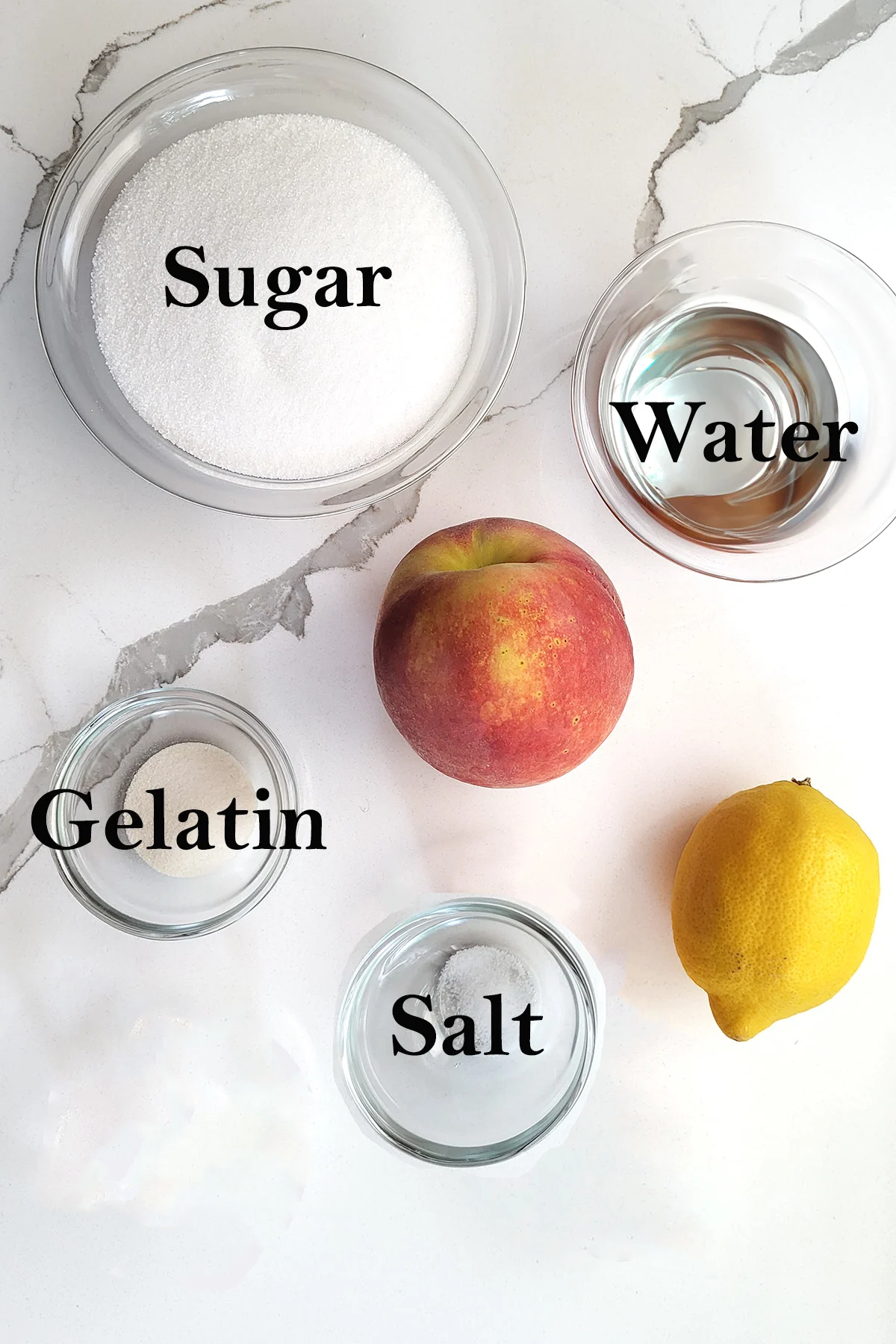 ingredients for peach glaze in glass bowls on a white surface.