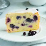 a slice of blueberry pound cake on a white plate.