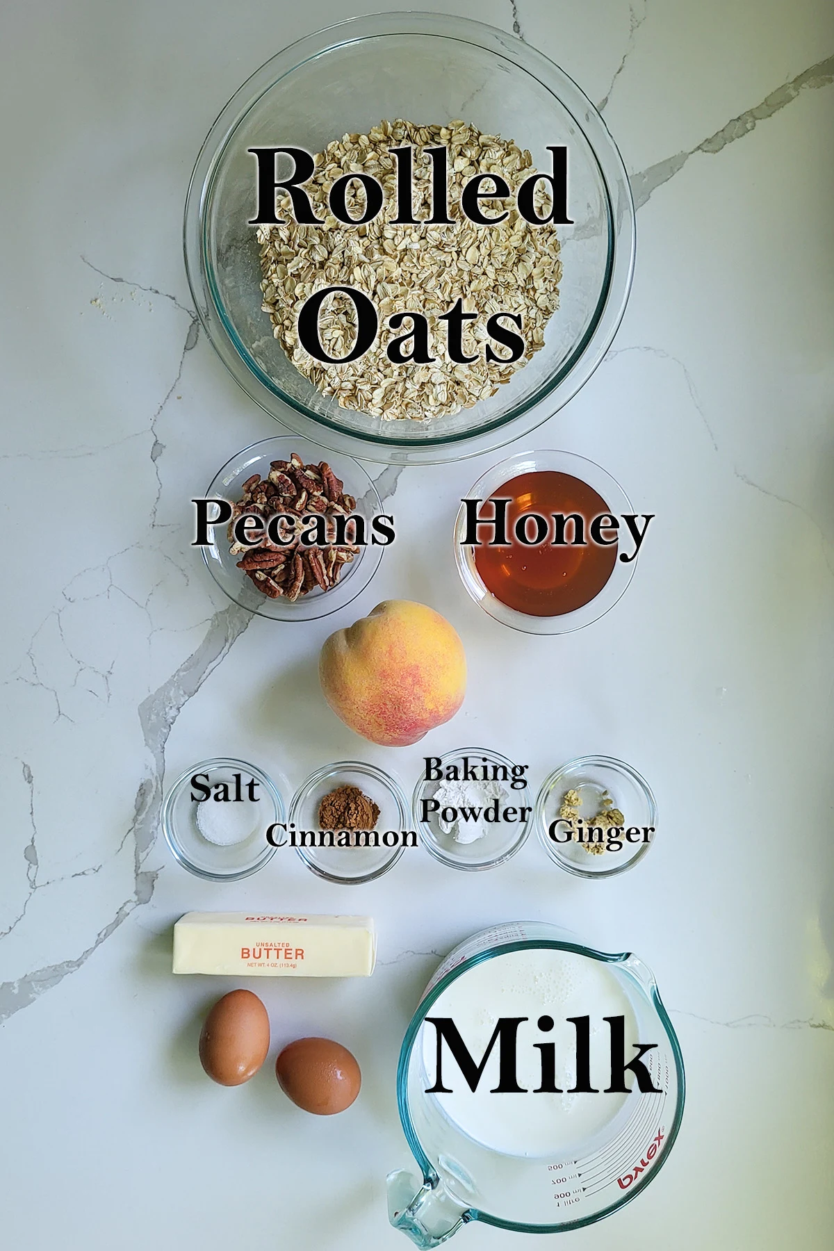 ingredients for peach baked oatmeal in glass bowls on a white surface.