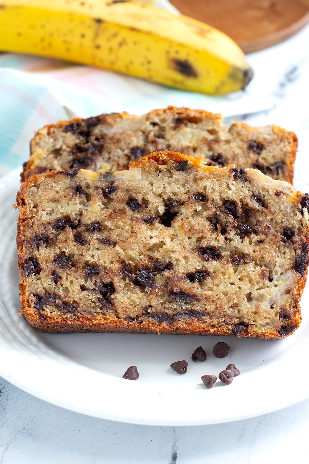 a slice of sourdough banana bread on a white plate.